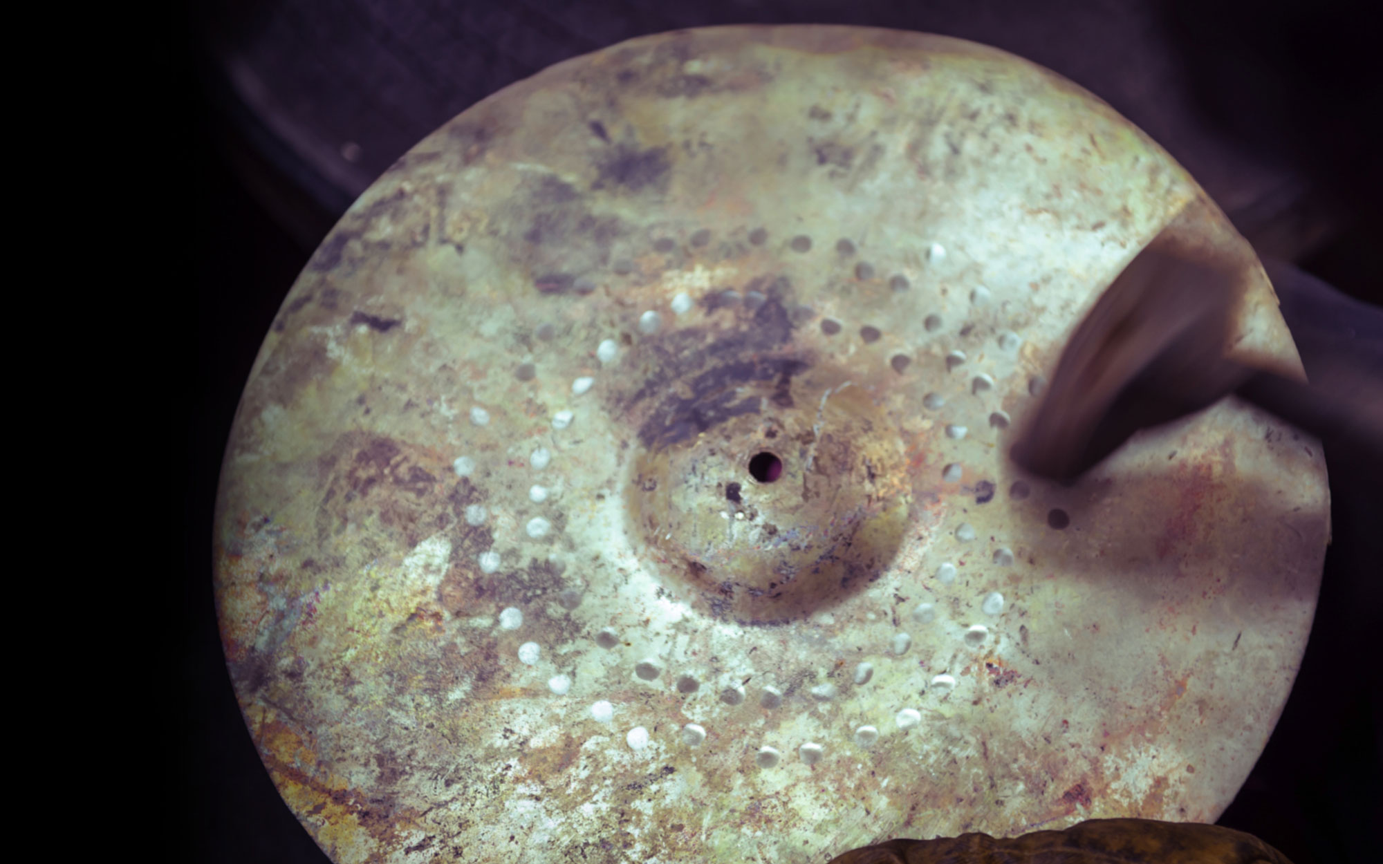 Hammering the cymbal